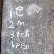 A P1 pupils' written work on a slate during a phonics lesson.